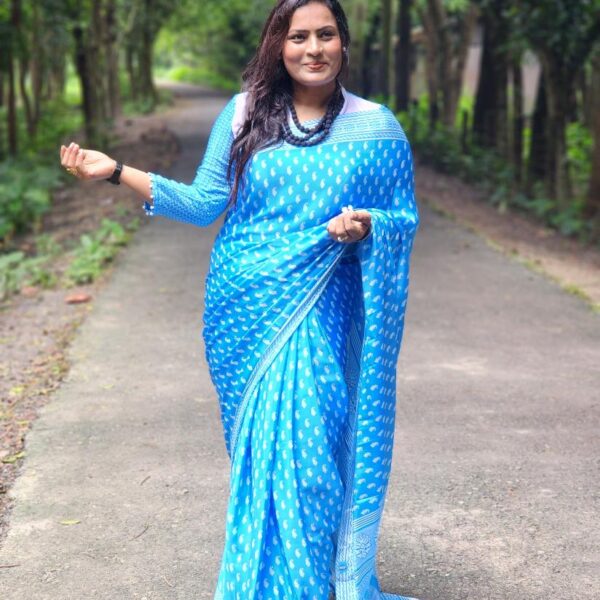 Premium digital-print silk saree featuring vibrant motifs and a matching running blouse piece. Lightweight, smooth drape — perfect for festive and formal wear.